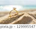 wedding ring on the sand 129995547