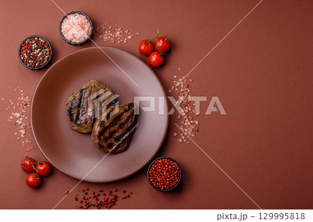 Grilled beef steak meat with salt and pepper. Beef steak grilled on a barbecue 129995818