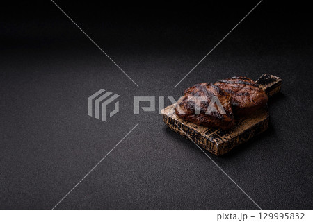 Grilled beef steak meat with salt and pepper. Beef steak grilled on a barbecue Grilled beef steak meat with salt and pepper. Beef steak grilled on a barbecue 129995832