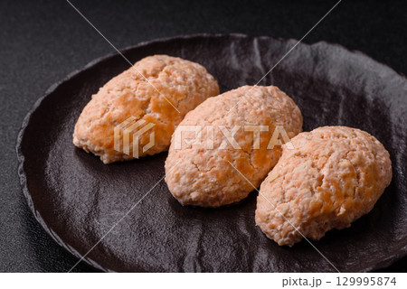 Steamed fish or chicken cutlets or meatballs with salt and spices. Fish cutlets 129995874