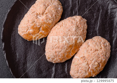 Steamed fish or chicken cutlets or meatballs with salt and spices. Fish cutlets 129995875
