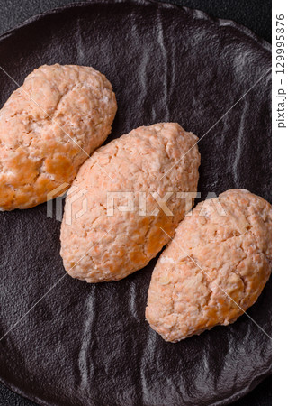 Steamed fish or chicken cutlets or meatballs with salt and spices. Fish cutlets 129995876