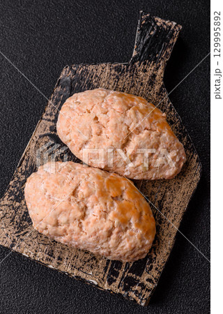 Steamed fish or chicken cutlets or meatballs with salt and spices. Fish cutlets 129995892