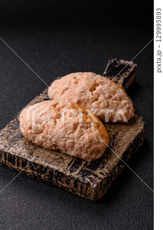 Steamed fish or chicken cutlets or meatballs with salt and spices. Fish cutlets 129995893