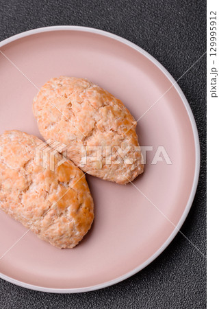 Steamed fish or chicken cutlets or meatballs with salt and spices. Fish cutlets 129995912