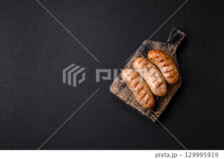 Grilled chicken or beef sausages, a hot meat dish. Barbecued sausages 129995919