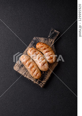 Grilled chicken or beef sausages, a hot meat dish. Barbecued sausages 129995920