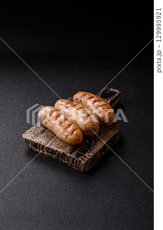 Grilled chicken or beef sausages, a hot meat dish. Barbecued sausages 129995921
