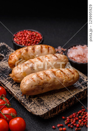 Grilled chicken or beef sausages, a hot meat dish. Barbecued sausages 129995929
