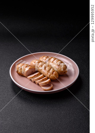 Grilled chicken or beef sausages, a hot meat dish. Barbecued sausages 129995952