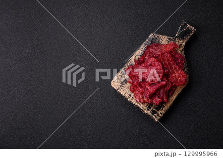 Jerky or dried chicken and cherry snacks. Dehydrated, dried snacks for beer 129995966