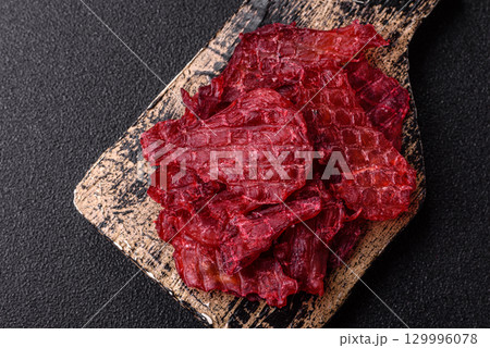 Jerky or dried chicken and cherry snacks. Dehydrated, dried snacks for beer Jerky or dried chicken and cherry snacks. Dehydrated, dried snacks for beer 129996078