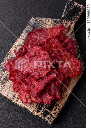 Jerky or dried chicken and cherry snacks. Dehydrated, dried snacks for beer 129996080