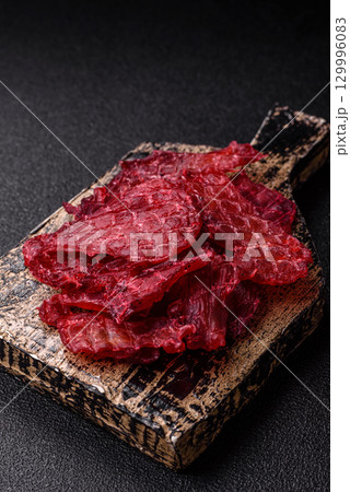 Jerky or dried chicken and cherry snacks. Dehydrated, dried snacks for beer 129996083