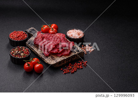 Jerky or dried chicken and cherry snacks. Dehydrated, dried snacks for beer 129996093