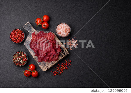 Jerky or dried chicken and cherry snacks. Dehydrated, dried snacks for beer 129996095