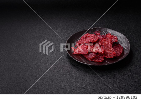 Jerky or dried chicken and cherry snacks. Dehydrated, dried snacks for beer 129996102