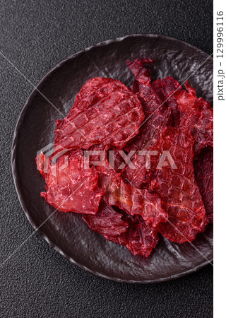 Jerky or dried chicken and cherry snacks. Dehydrated, dried snacks for beer Jerky or dried chicken and cherry snacks. Dehydrated, dried snacks for beer 129996116