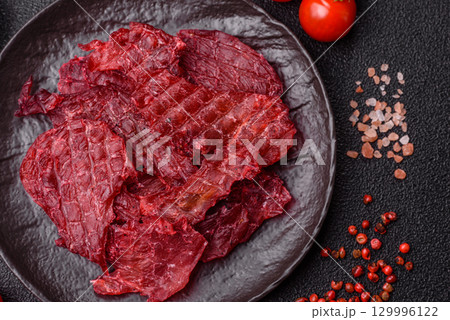 Jerky or dried chicken and cherry snacks. Dehydrated, dried snacks for beer 129996122