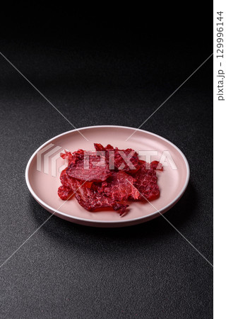 Jerky or dried chicken and cherry snacks. Dehydrated, dried snacks for beer 129996144