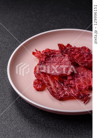 Jerky or dried chicken and cherry snacks. Dehydrated, dried snacks for beer Jerky or dried chicken and cherry snacks. Dehydrated, dried snacks for beer 129996151