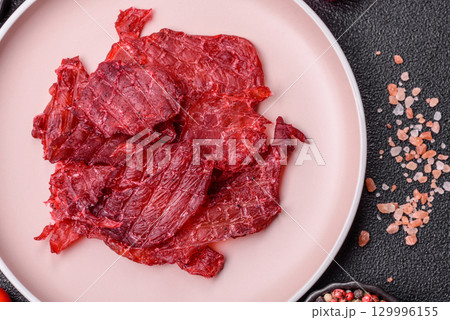 Jerky or dried chicken and cherry snacks. Dehydrated, dried snacks for beer 129996155