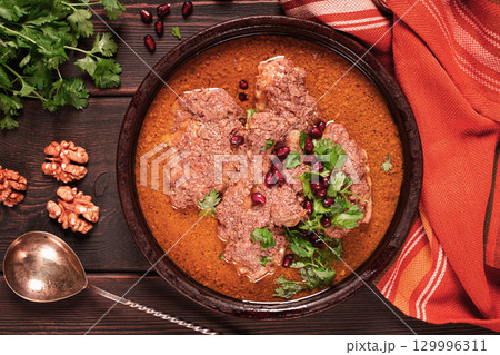 fesenjan, an Iranian dish, stewed chicken, in walnut-pomegranate sauce, in an earthen pan, homemade, no people, fesenjan, an Iranian dish, stewed chicken, in walnut-pomegranate sauce, in an earthen pan, homemade, no people, 129996311