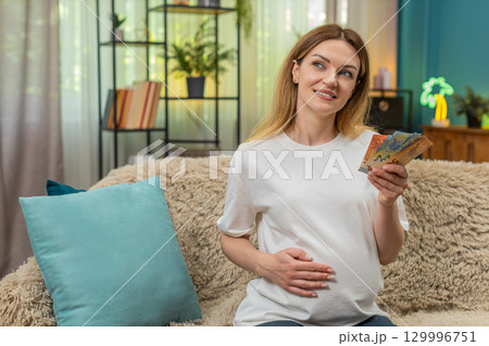 Pregnant woman counts euro cash planning baby birth budget serious money management preparation Pregnant woman counts euro cash planning baby birth budget serious money management preparation 129996751
