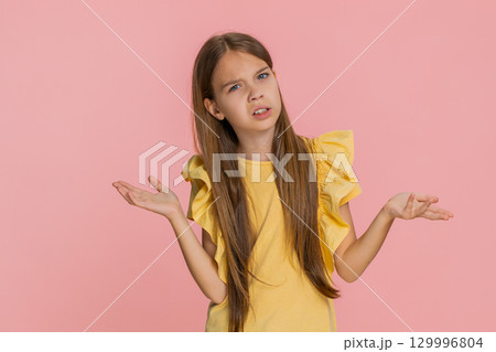 Child girl kid raising eyebrows in surprise showing gesture what why with puzzled emotional reaction Child girl kid raising eyebrows in surprise showing gesture what why with puzzled emotional reaction 129996804