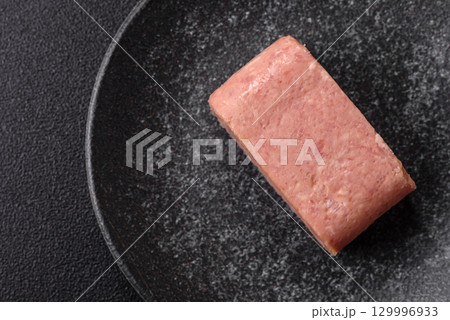 Food, meat, ham sliced in slices for the festive table. Spiced ham 129996933