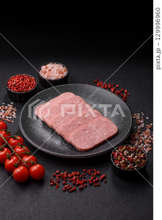 Food, meat, ham sliced in slices for the festive table. Spiced ham 129996960