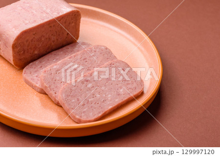 Food, meat, ham sliced in slices for the festive table. Spiced ham 129997120