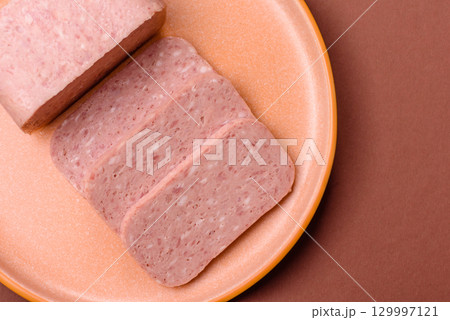 Food, meat, ham sliced in slices for the festive table. Spiced ham 129997121