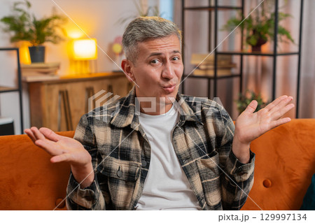 Frustrated man asking why, what reason of failure, demonstrating disbelief irritation by troubles 129997134