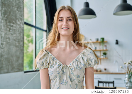 Headshot portrait young beautiful blonde female 18-20 years old in home interior Headshot portrait young beautiful blonde female 18-20 years old in home interior 129997186