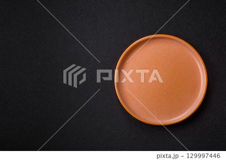 Empty round black plate for food, kitchen utensils on dining table. Empty plate Empty round black plate for food, kitchen utensils on dining table. Empty plate 129997446