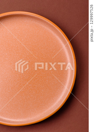 Empty round black plate for food, kitchen utensils on dining table. Empty plate Empty round black plate for food, kitchen utensils on dining table. Empty plate 129997526