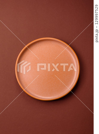 Empty round black plate for food, kitchen utensils on dining table. Empty plate Empty round black plate for food, kitchen utensils on dining table. Empty plate 129997529