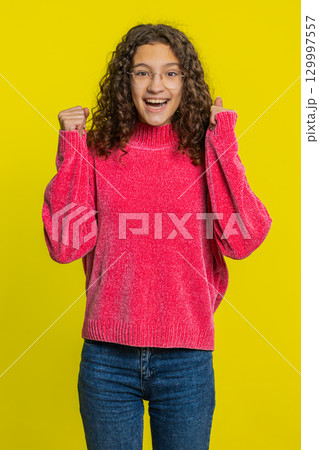 Happy Caucasian girl celebrate success winning birthday lottery jackpot goal achievement good news Happy Caucasian girl celebrate success winning birthday lottery jackpot goal achievement good news 129997557