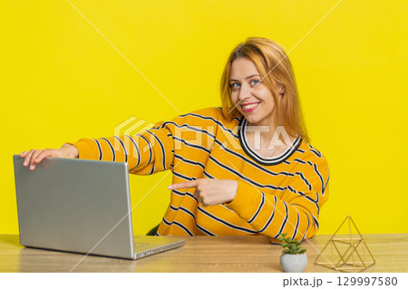 Woman working online on laptop, recommend program application game, positive feedback good offer Woman working online on laptop, recommend program application game, positive feedback good offer 129997580