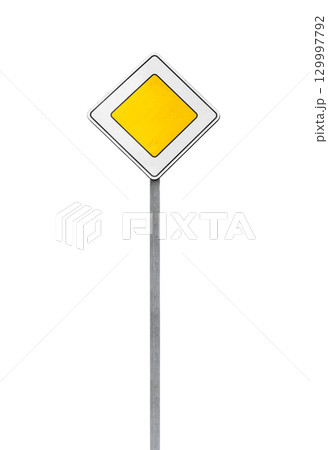 A yellow priority road traffic sign mounted on a metal post, isolated on white A yellow priority road traffic sign mounted on a metal post, isolated on white 129997792
