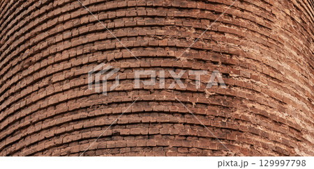 Detailed texture of an ancient round tower red bricks wall 129997798
