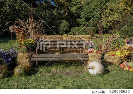A herd of sheep standing on top of a lush green field A herd of sheep standing on top of a lush green field 129998689