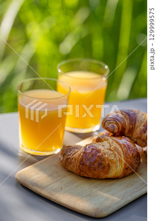 orange juice and croissants orange juice and croissants 129999575