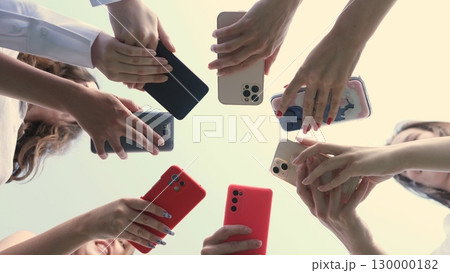 A diverse collection of hands holding various models of smartphones, symbolizing connectivity in technology 130000182