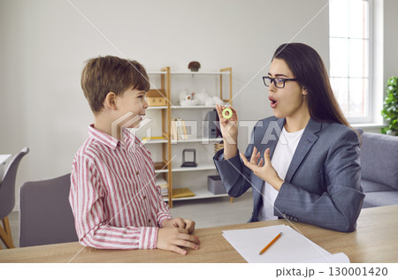Woman speech therapist and child boy practicing private development lesson in office. 130001420