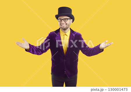 Entertainer in purple suit and top hat spreading his arms and welcoming you to show 130001473