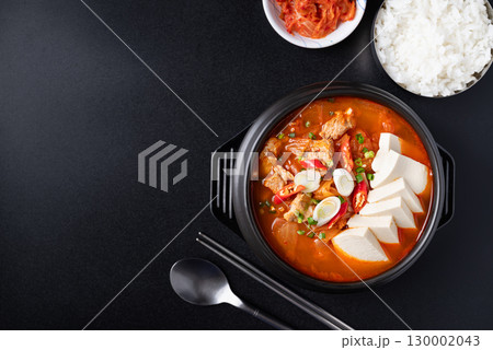 Korean food (Kimchi Jjigae), Kimchi soup with tofu and pork in Korean stone bowl  130002043
