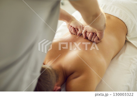 Rehabilitation spine massage closeup, exercise for patient, spinal therapy by physical therapist  130003322