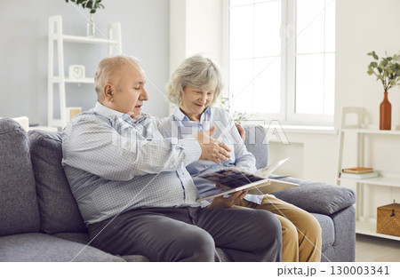 Elderly Family Couple Looking At Photo Album Together Elderly Family Couple Looking At Photo Album Together 130003341